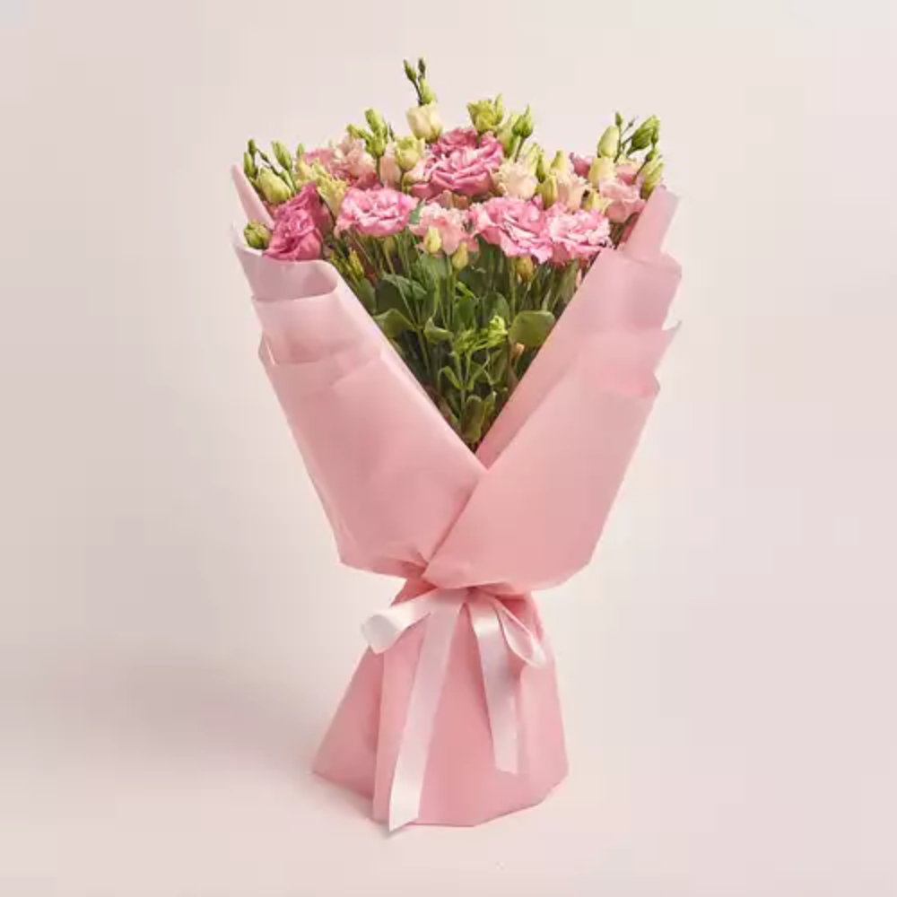 Fresh pink lisianthus bouquet wrapped in soft pink paper with a white satin ribbon