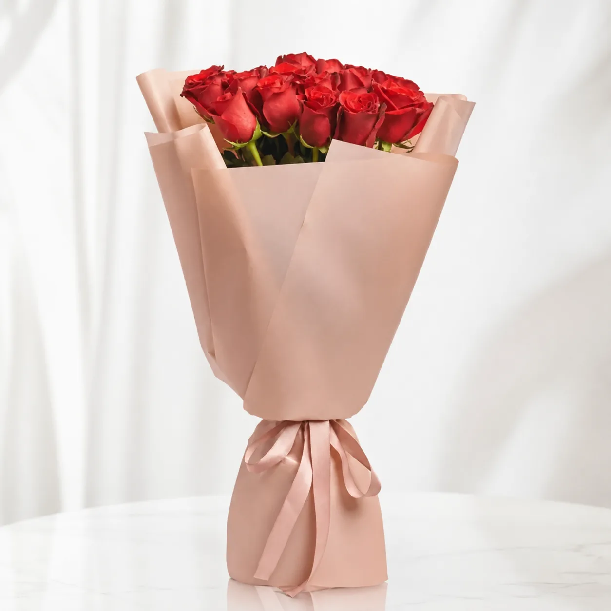 Classic red rose bouquet wrapped in elegant beige paper with a matching ribbon