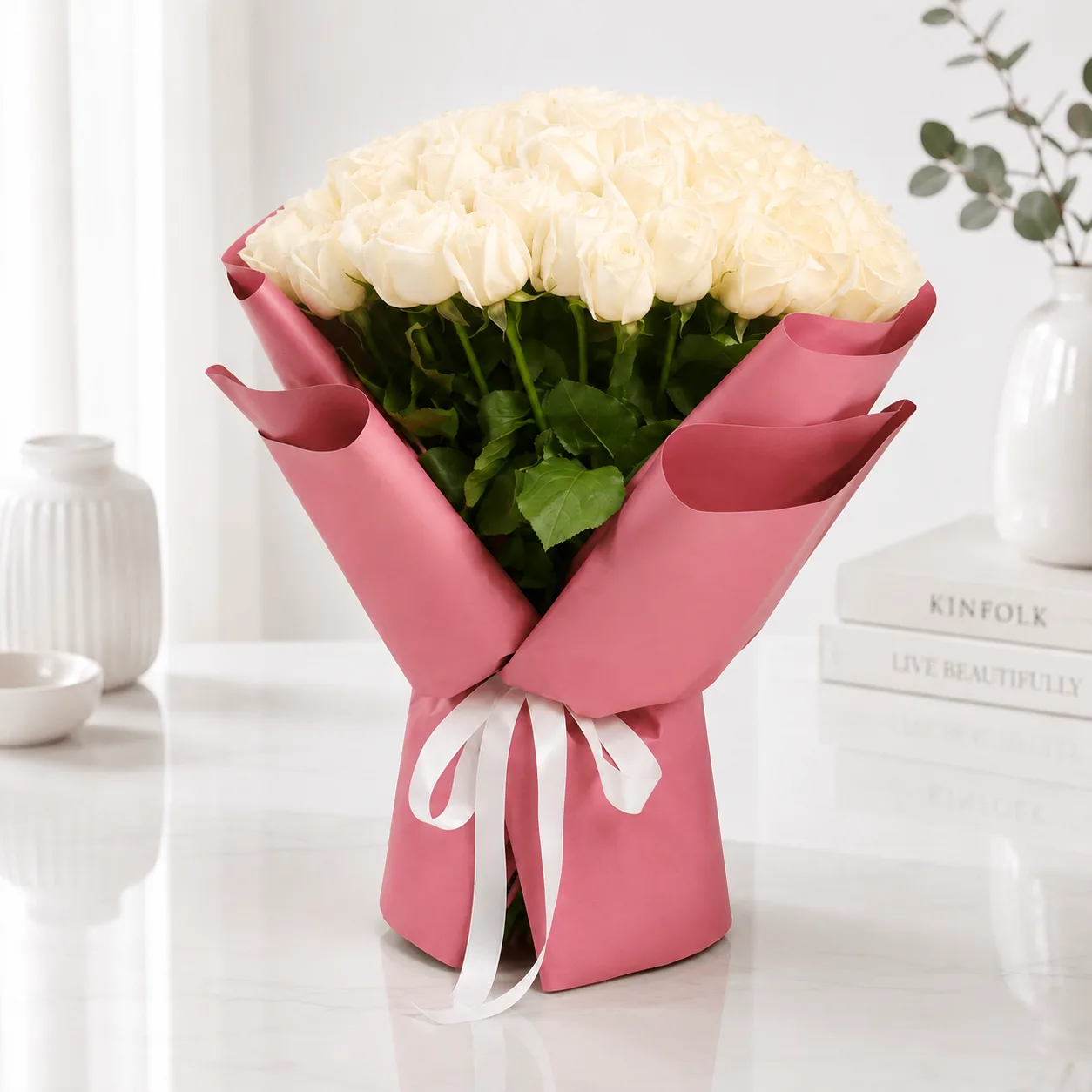 Elegant bouquet of fresh pink roses wrapped in premium pastel paper with a soft ribbon, perfect for romantic gifting, anniversaries, and special occasions in Dubai.