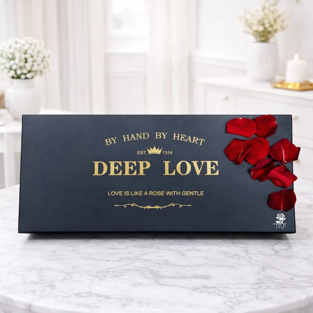 Closed black "Deep Love" gift box with gold lettering and red rose petals on the lid.