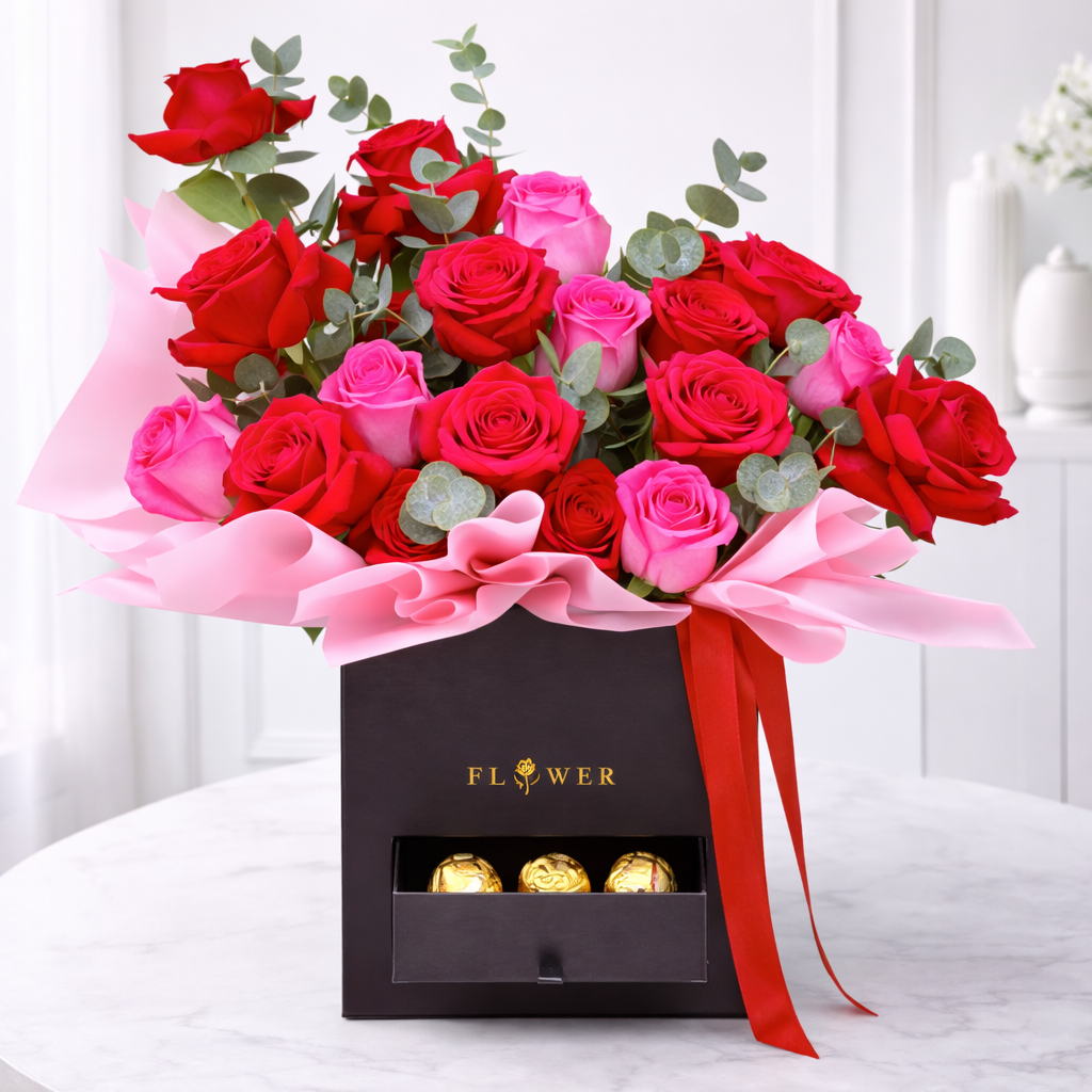 Red and pink rose arrangement in black box with chocolate drawer