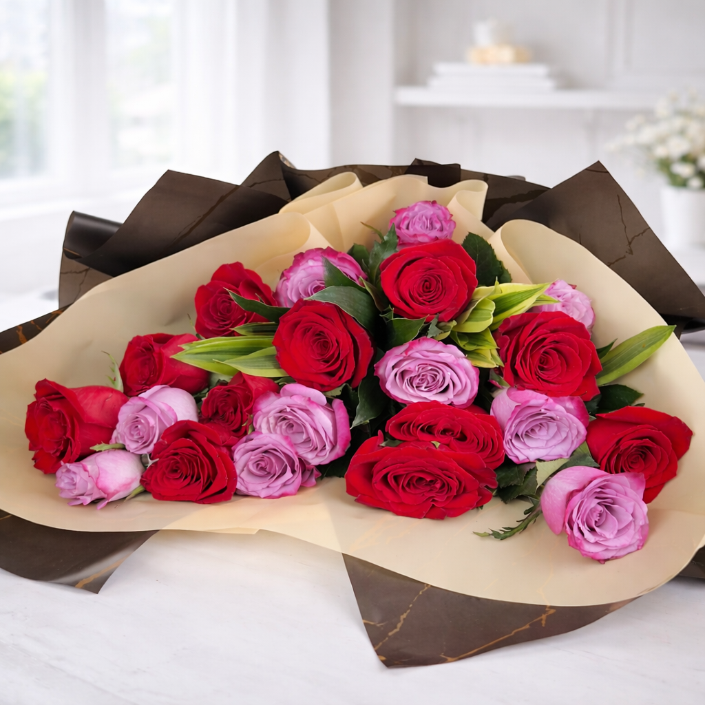 Red and pink roses bouquet wrapped in black and beige luxury paper
