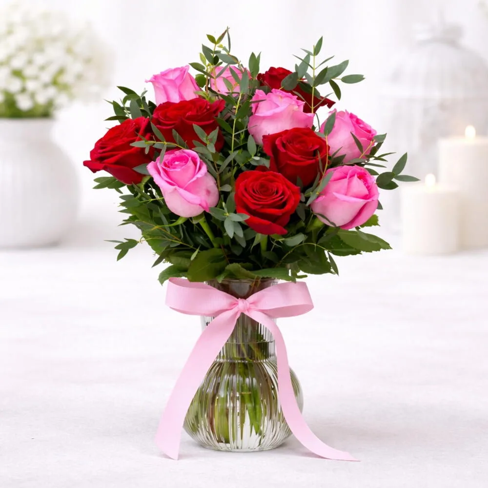 The Moonlit Oasis is a vibrant floral arrangement designed within a modern, white crescent moon-shaped stand.