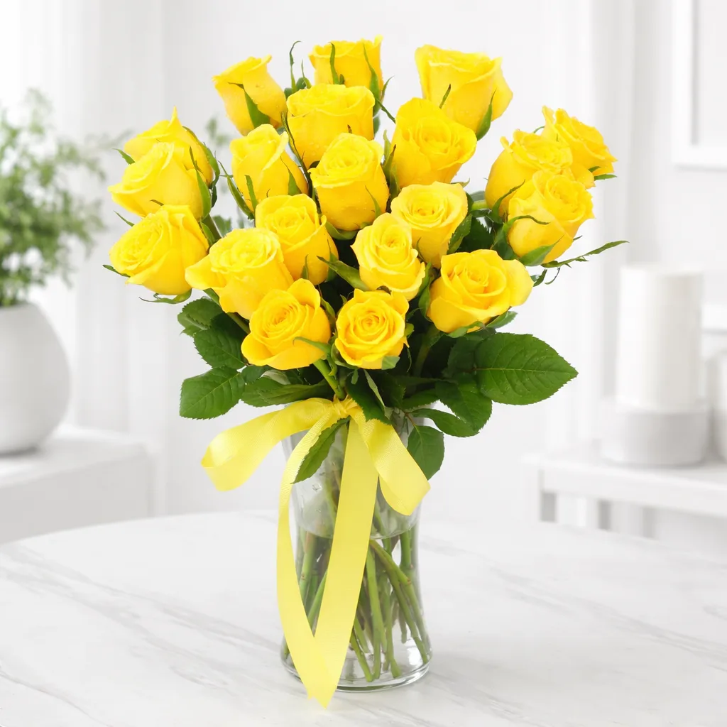 Yellow rose bouquet in glass vase with ribbon on table