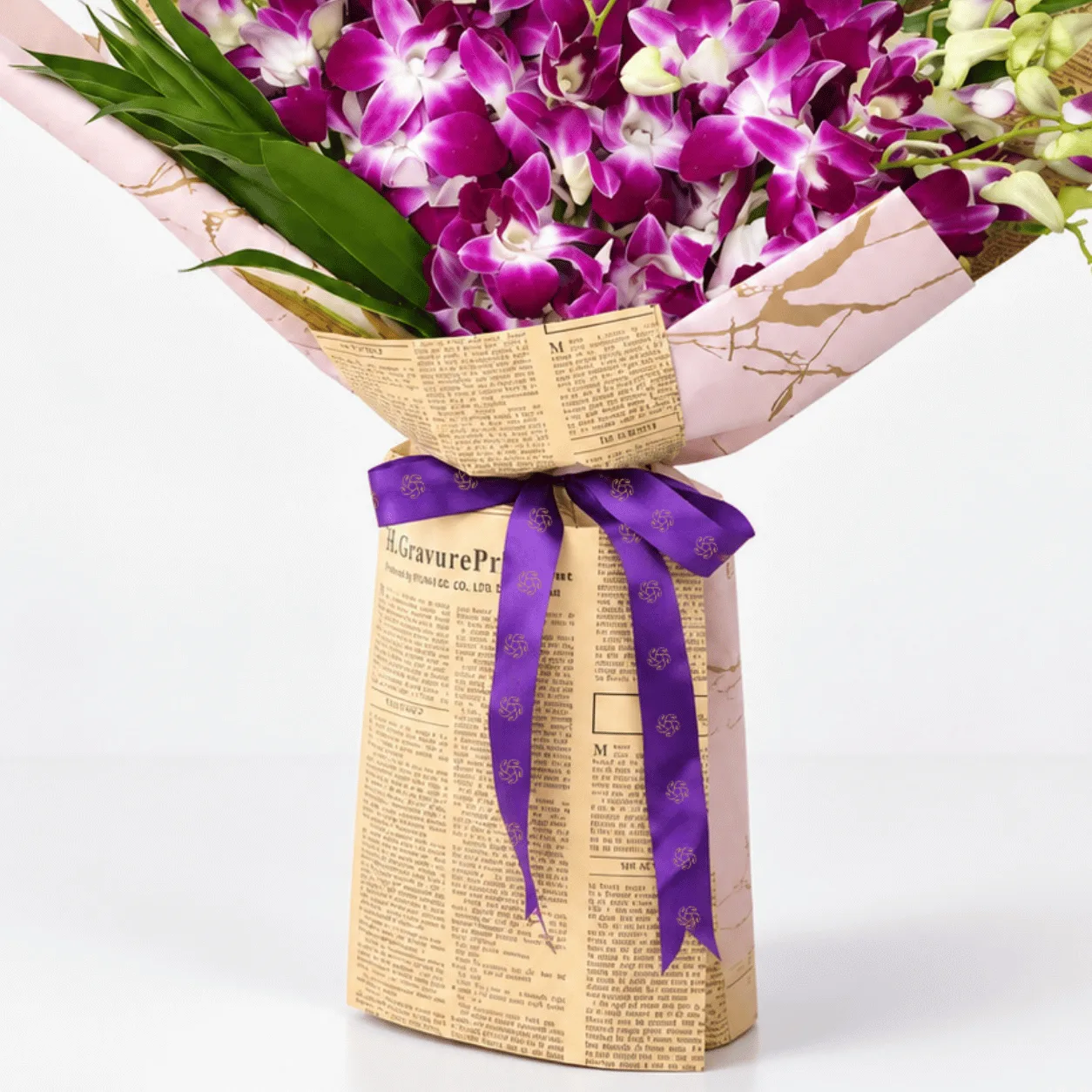 Fresh purple orchids arranged in a stylish hand-tied bouquet for memorable celebrations.