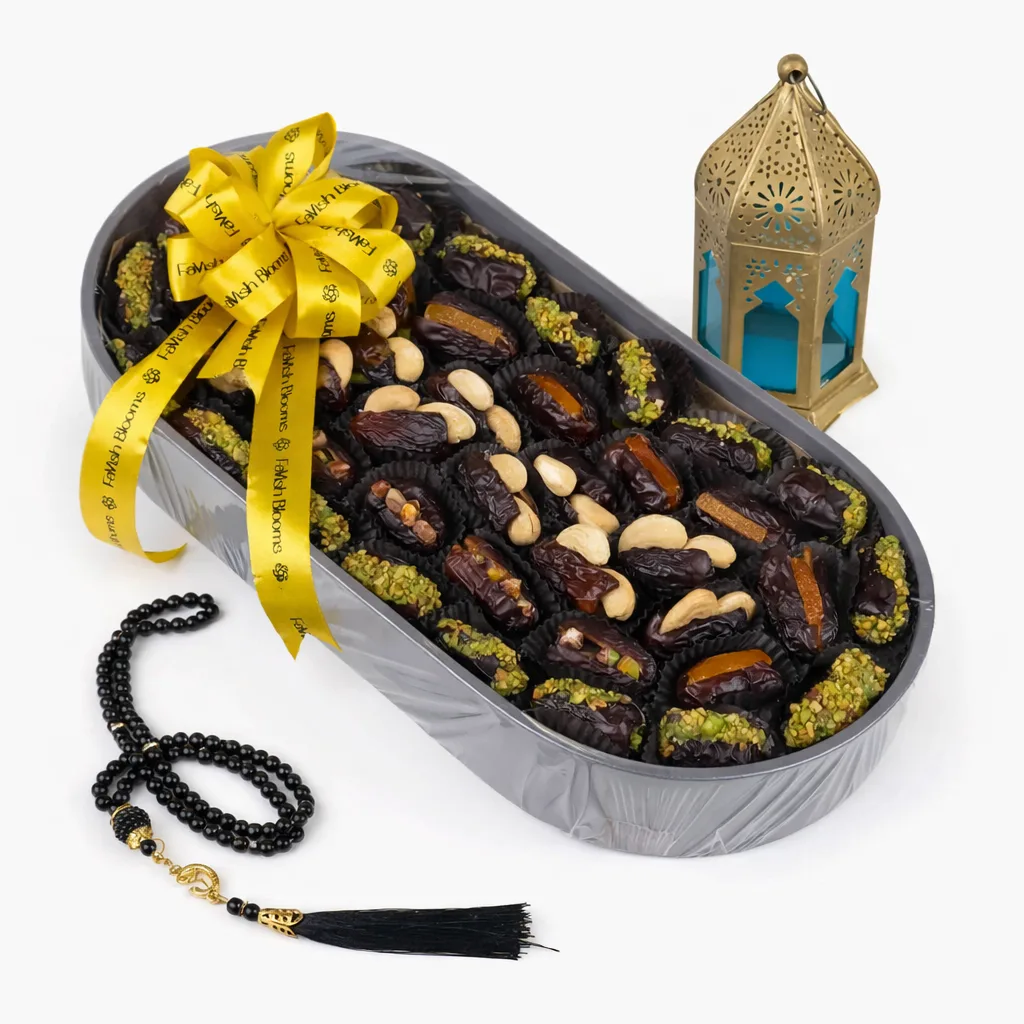FaVish Blooms stuffed dates gift tray with a gold ribbon bow, black prayer beads, and a gold Moroccan lantern.