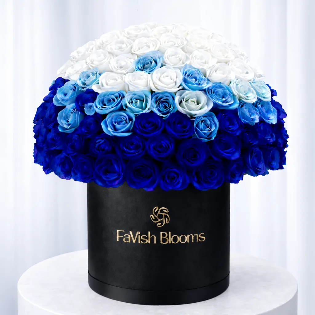 Ombre blue to white rose arrangement in a black FaVish Blooms luxury hat box.
