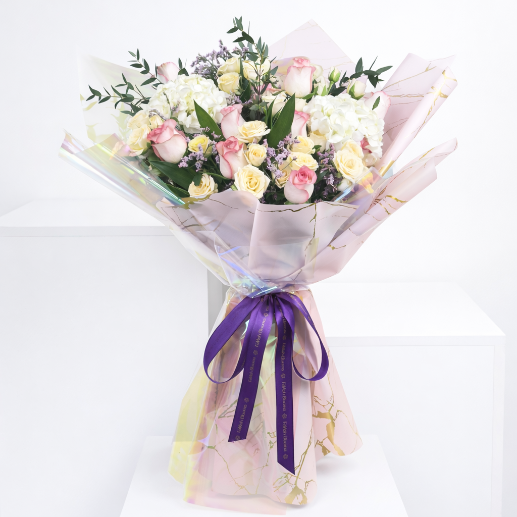 Pink and cream roses with hydrangea bouquet in luxury iridescent marble wrapping.
