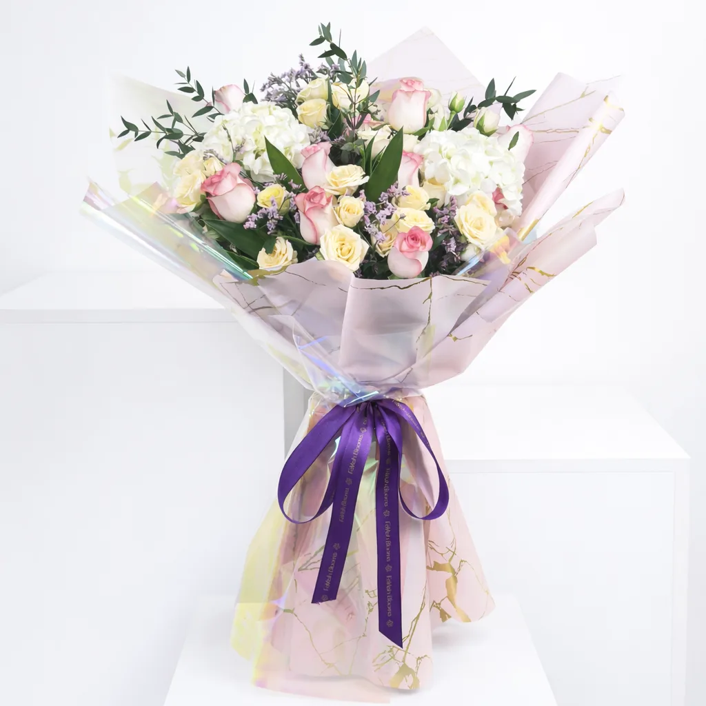 Pink and cream roses with hydrangea bouquet in luxury iridescent marble wrapping.
