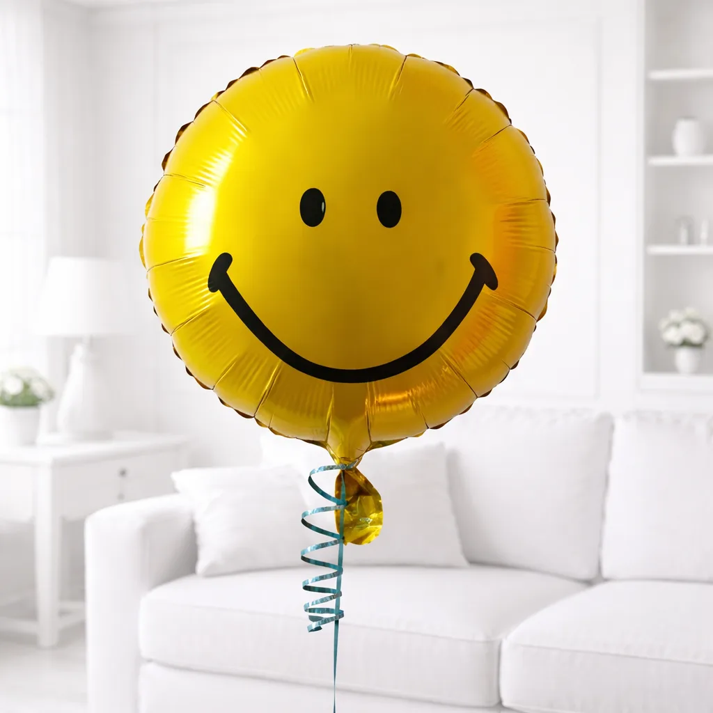 Yellow smiley face foil balloon with blue curling ribbon.