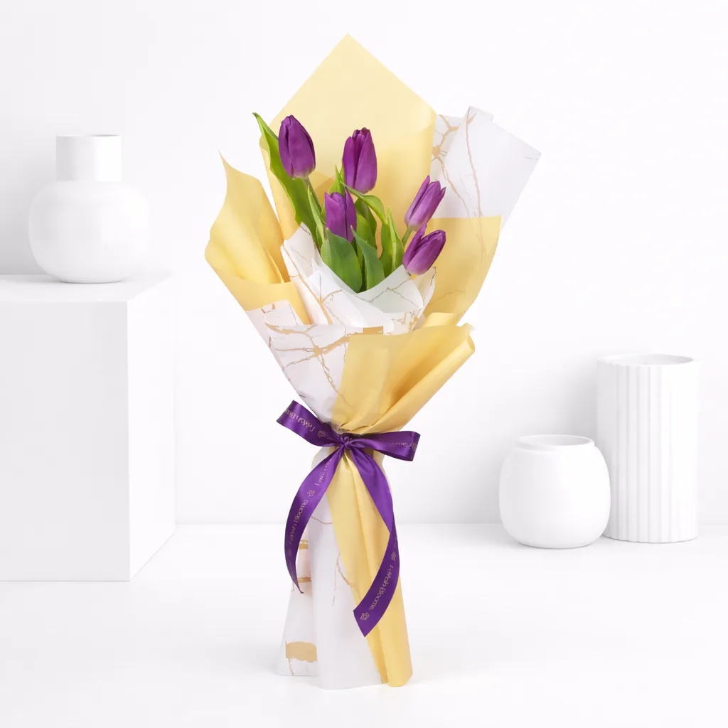 Purple tulip bouquet wrapped in gold and marble-print paper tied with a purple Favish Blooms ribbon.