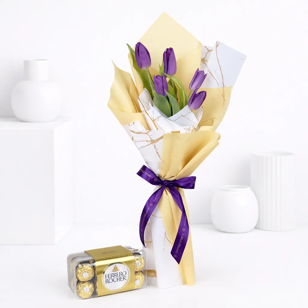 Purple tulips wrapped in gold and marble-print paper tied with a purple Favish Blooms ribbon, paired with a box of Ferrero Rocher chocolates.