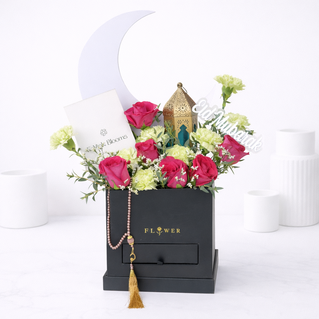 Eid Mubarak flower gift box with pink roses, green carnations, tasbih, and Moroccan lantern.