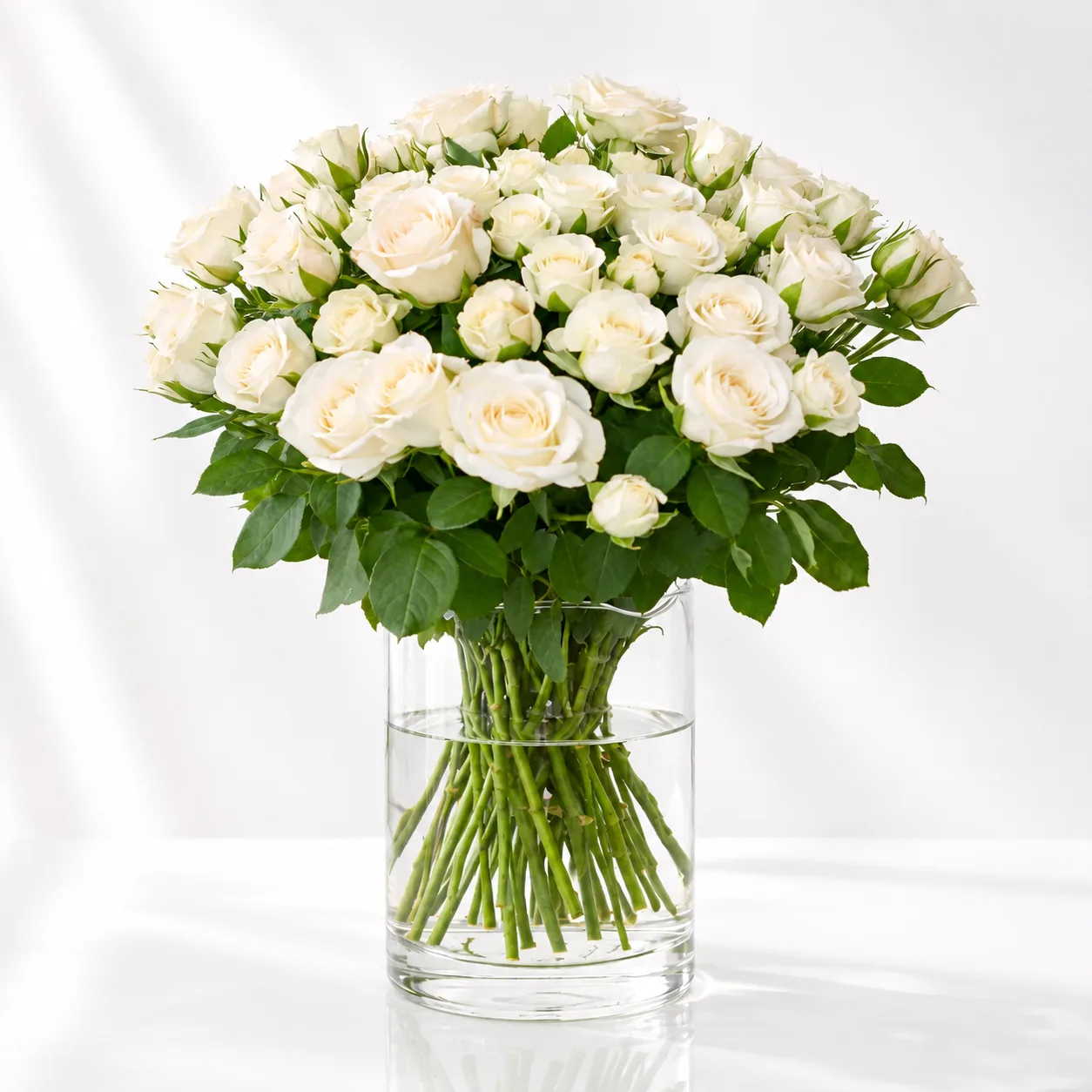 Elegant white spray roses vase arrangement by FaVish Blooms