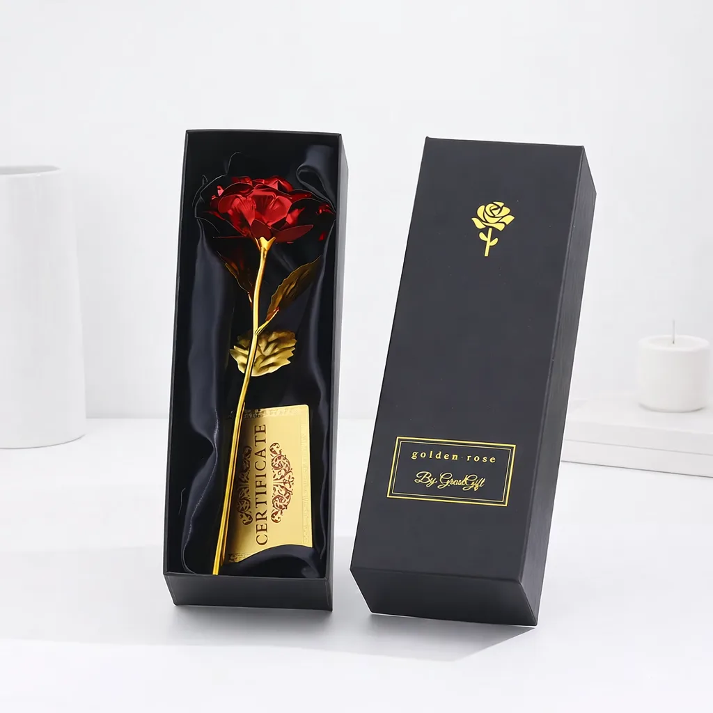 Red metallic artificial rose with a gold stem and certificate, displayed in an open black satin-lined gift box by Golden Rose.