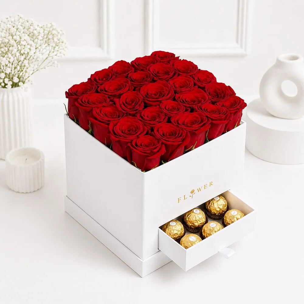 Luxury white box arrangement with 25 red roses and Ferrero Rocher chocolates in a drawer, styled on a white studio background.