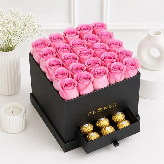 Premium black box arrangement with 25 pink roses and Ferrero Rocher chocolates in a drawer, styled on a white studio background.