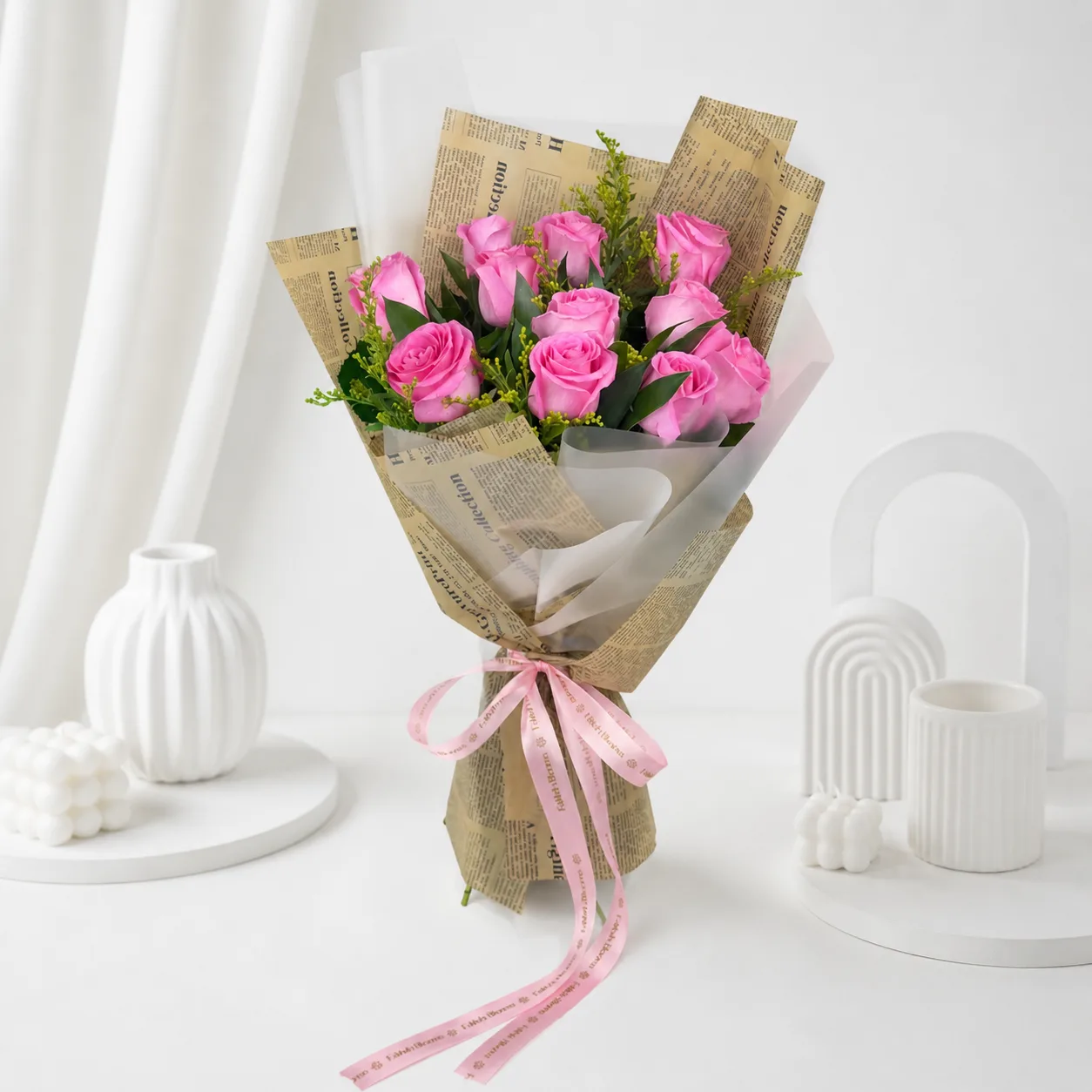Pink roses bouquet wrapped in brown paper with eucalyptus leaves.
