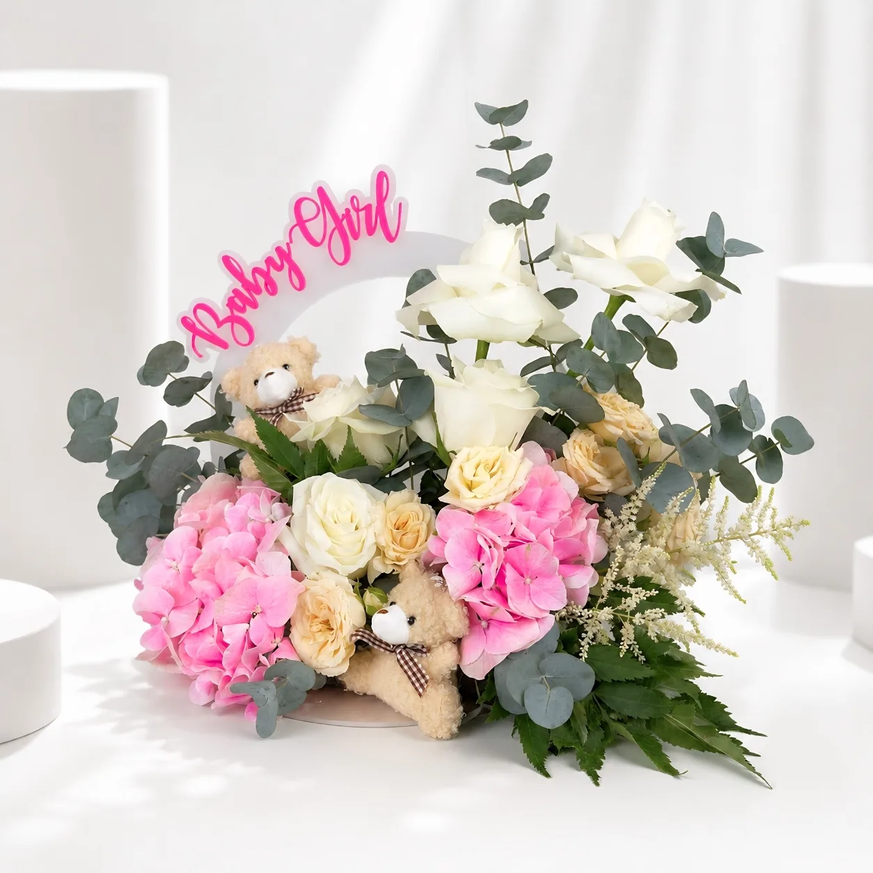 Elegant baby girl flower arrangement with white roses and eucalyptus