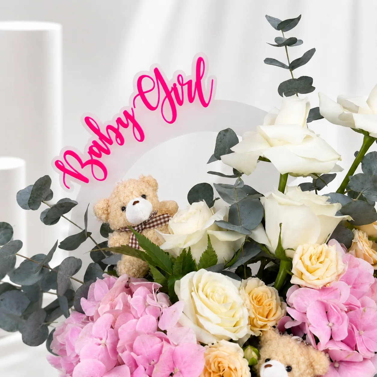 Close-up of baby girl floral arrangement with pink hydrangeas