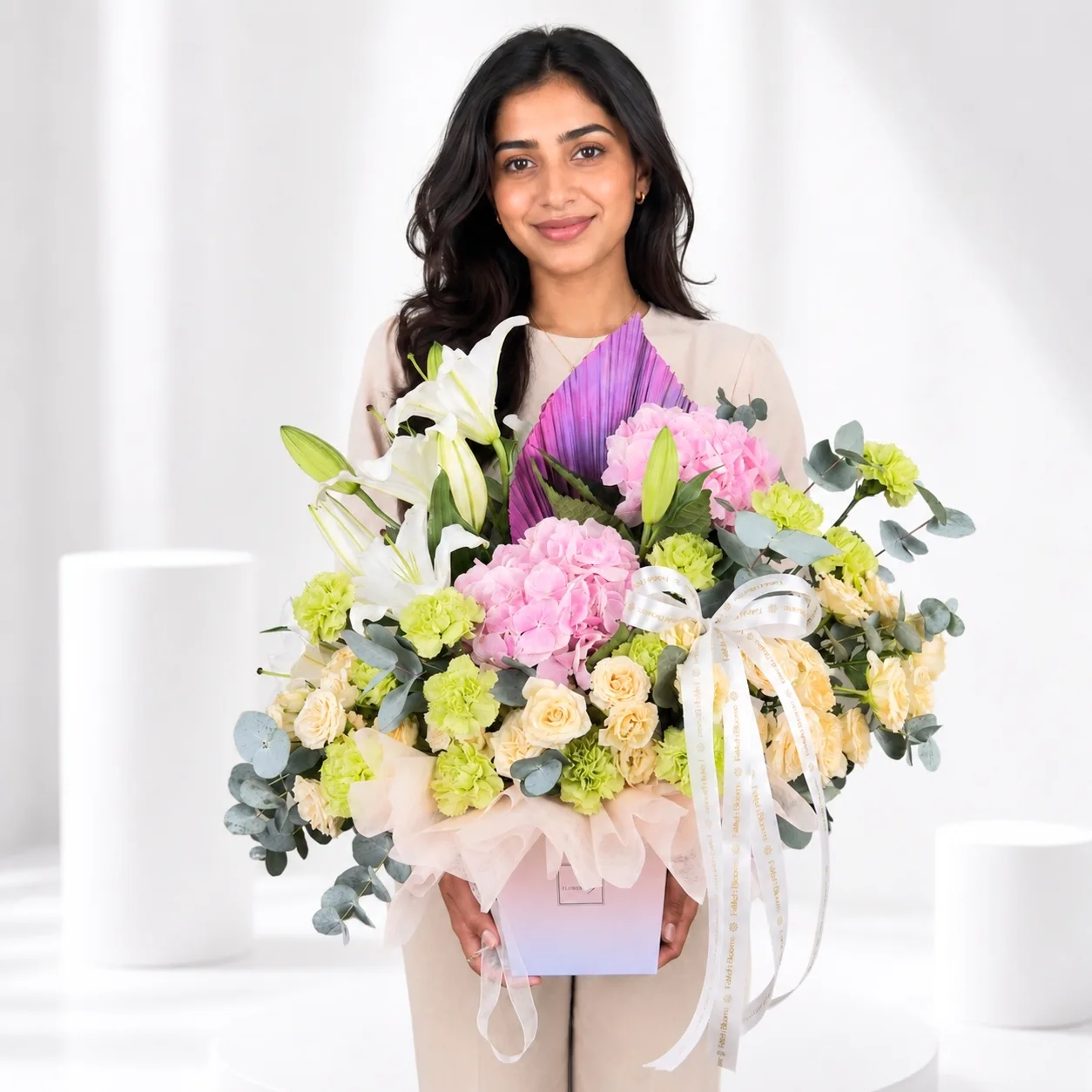 Woman holding luxury pastel flower bouquet by FaVish Blooms
