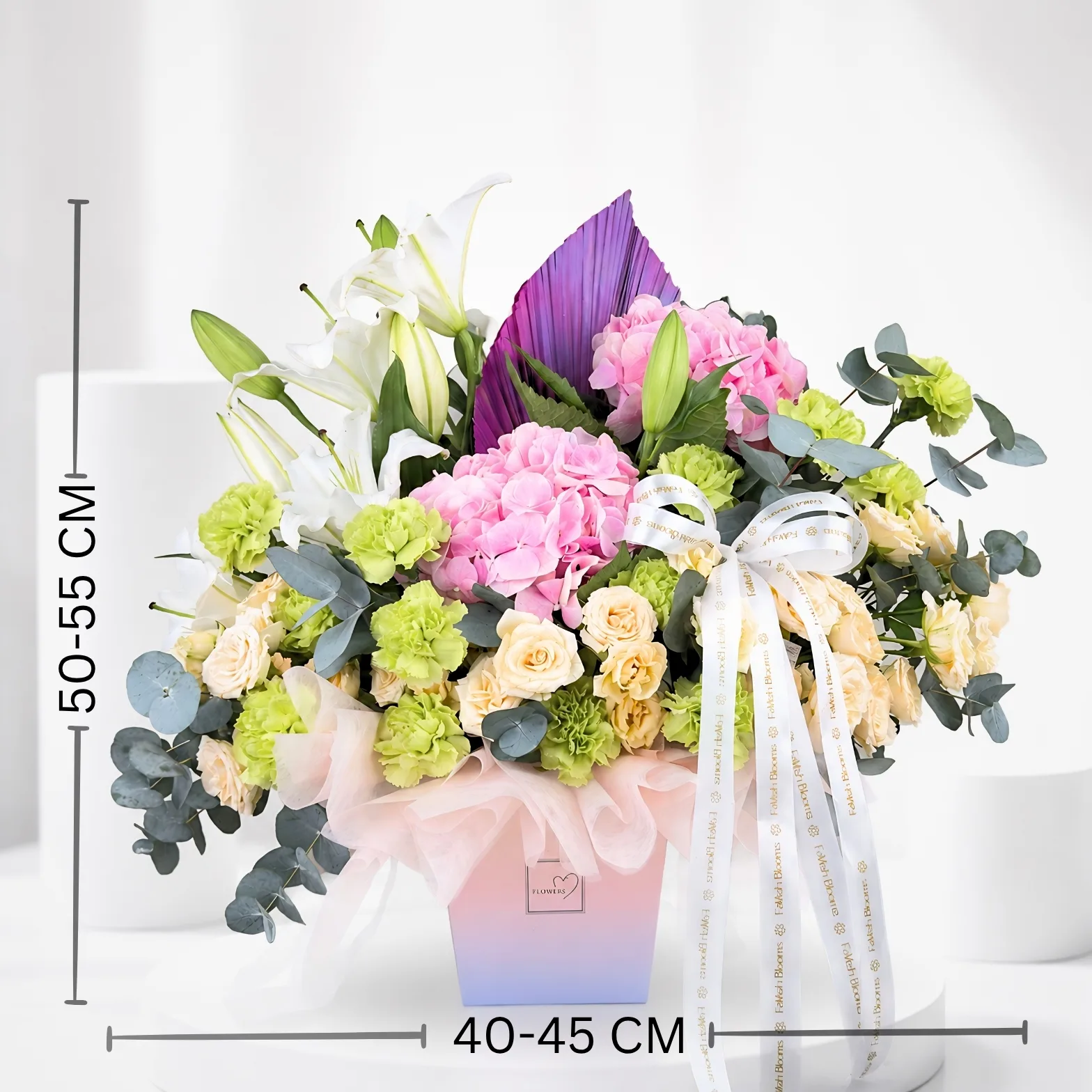 Pastel floral gift box with pink hydrangeas, lilies and eucalyptus leaves