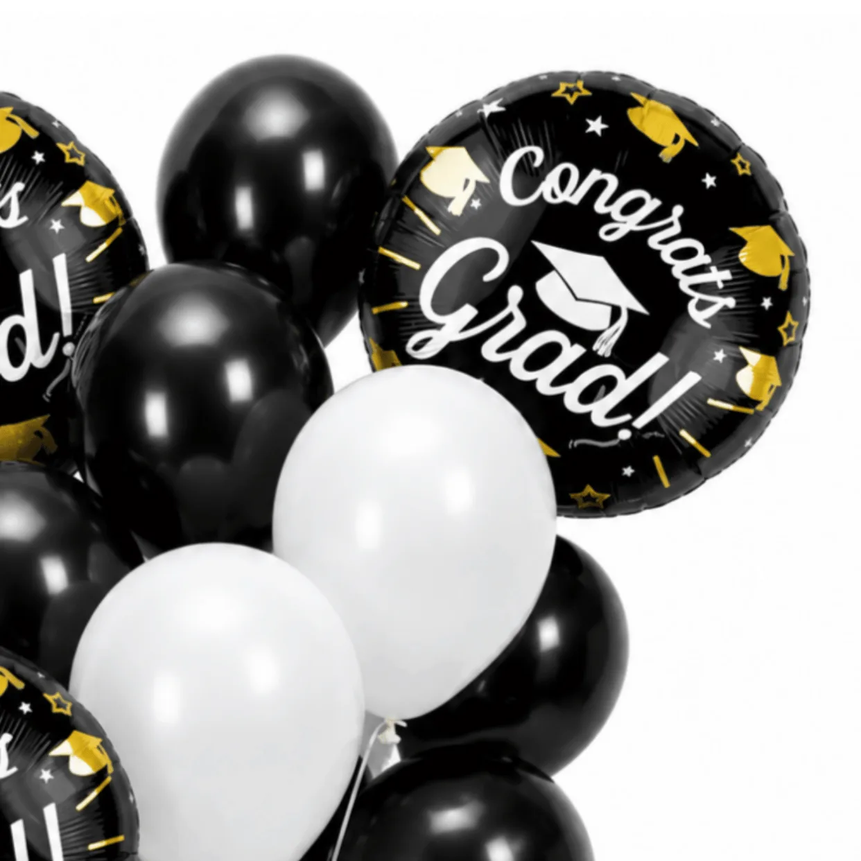 Close-up of black and white Congrats Grad helium balloons with graduation foil balloon details.