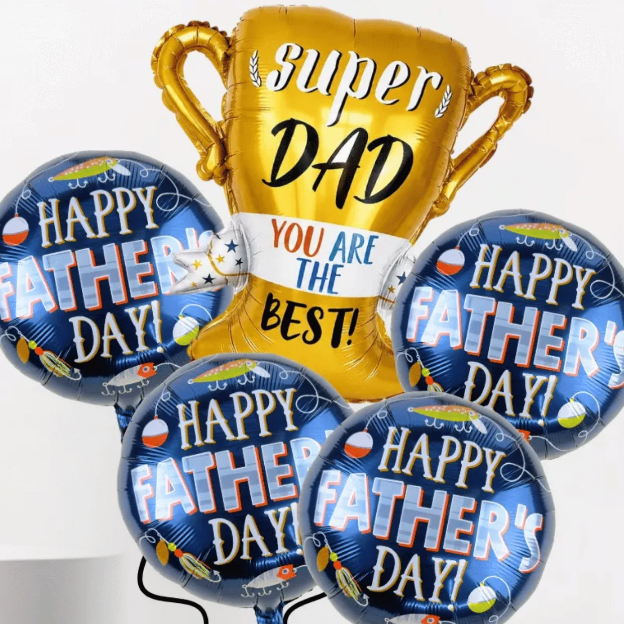 Close-up of Super Dad trophy foil balloon bouquet with blue Happy Father’s Day balloons.