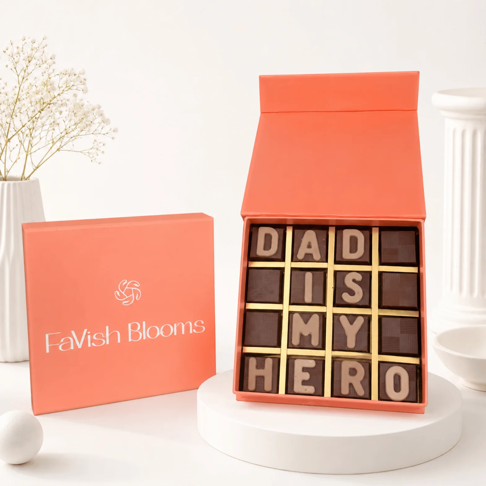 Dad Is My Hero luxury chocolate box with FaVish Blooms peach gift packaging on a premium white setup.