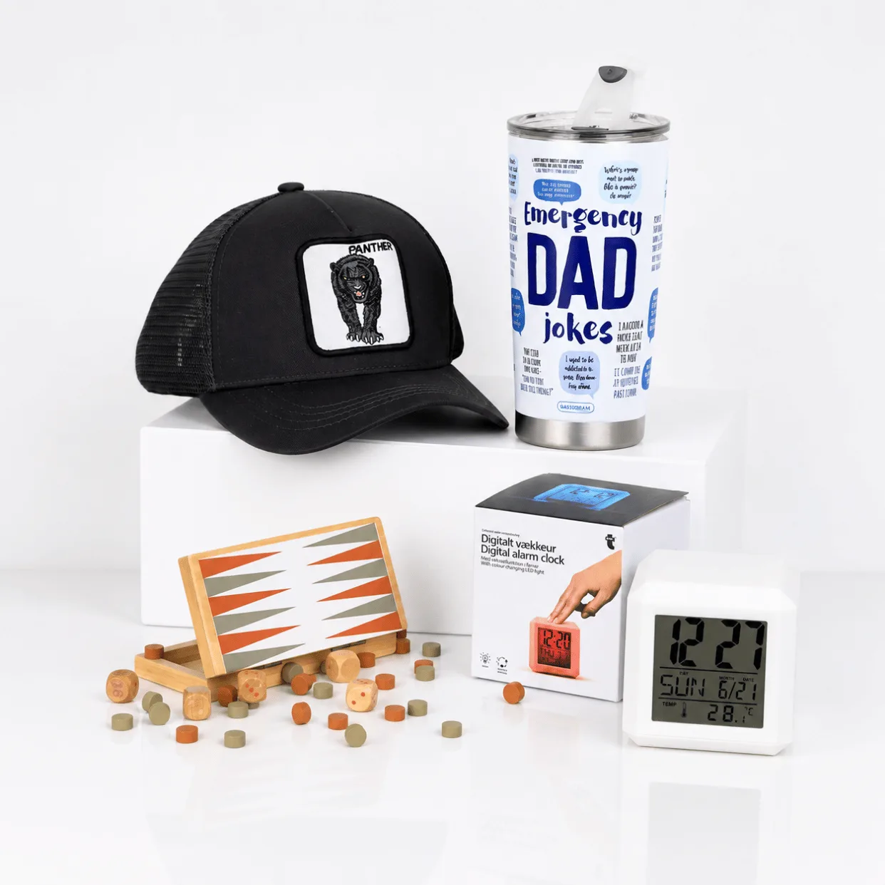 Father’s Day gift set with black panther cap, Emergency Dad Jokes tumbler, digital alarm clock and wooden game.