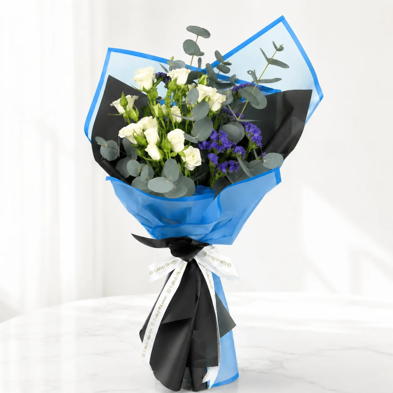 Fresh blue and white bouquet arranged with elegant flowers