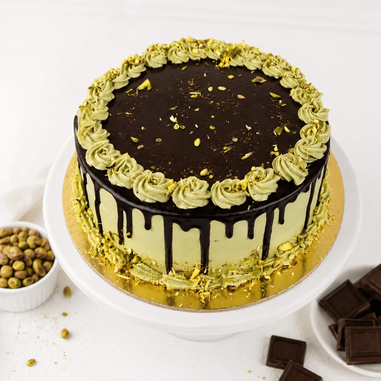 Fresh Pistachio Chocolate Drip Cake by FaVish Blooms Dubai for sweet gifting