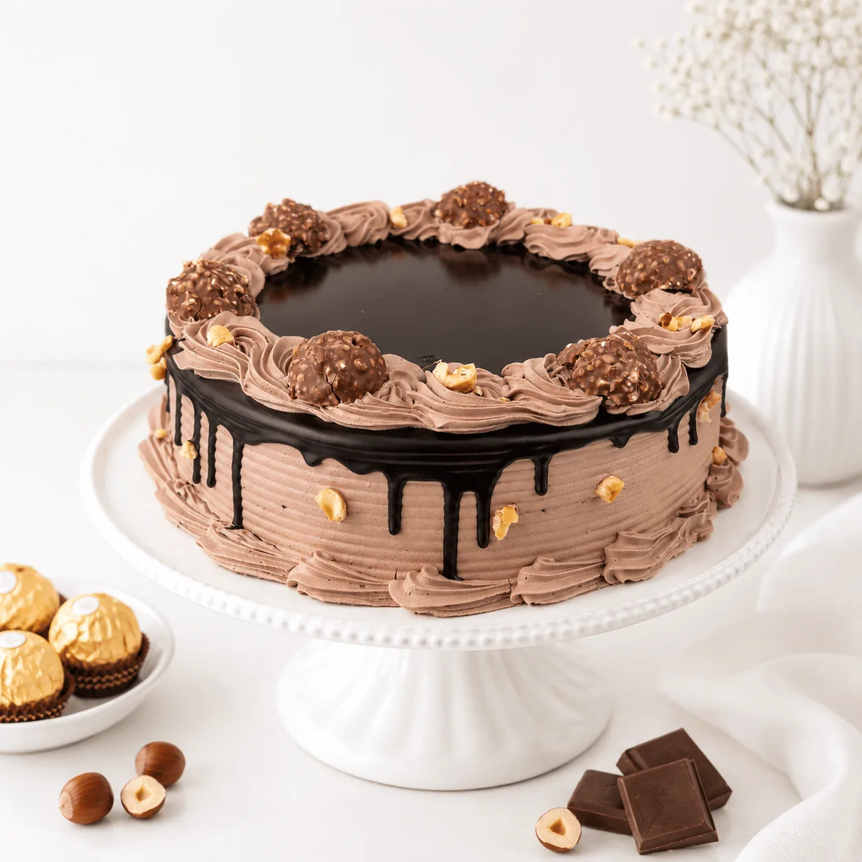 Premium Ferrero Rocher cake with fresh red rose bouquet by FaVish Blooms Dubai