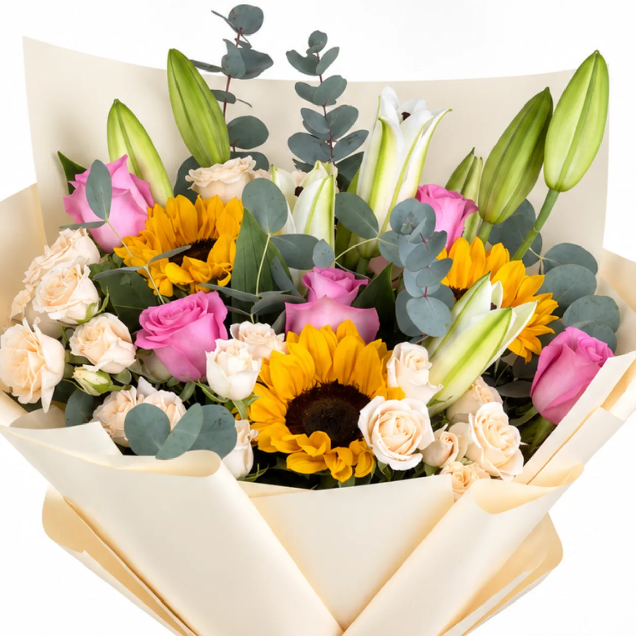 Close-up of sunflowers, pink roses, and white lilies in cream wrapped bouquet