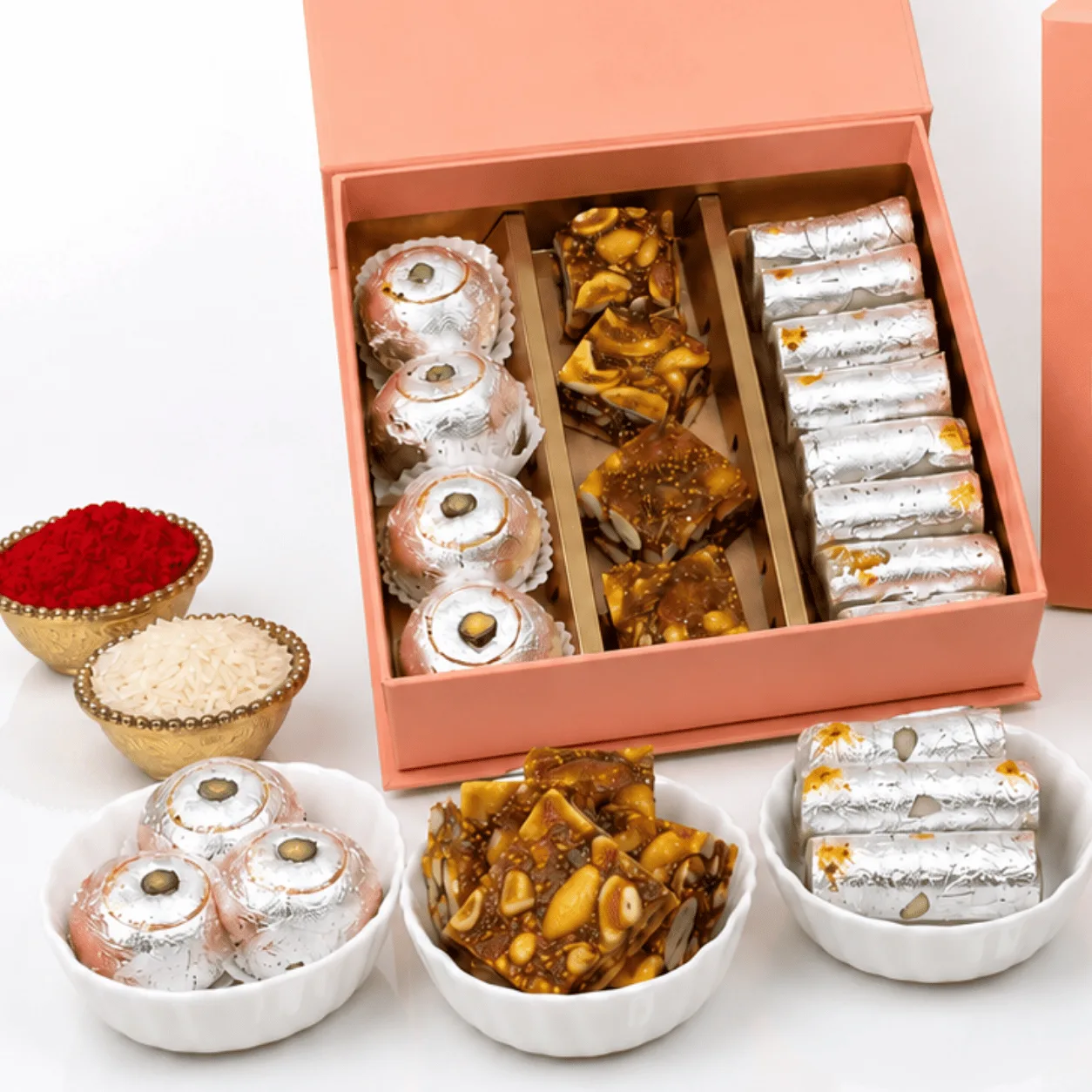 Raksha Bandhan sweets gift box with Ganesha idol and rakhi