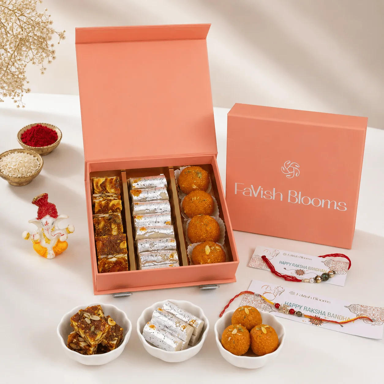 Premium Rakhi Sweets & Ganesha Gift Box with Kaju Katli, dry fruits, festive Rakhi, and Ganesha idol by FaVish Blooms Dubai