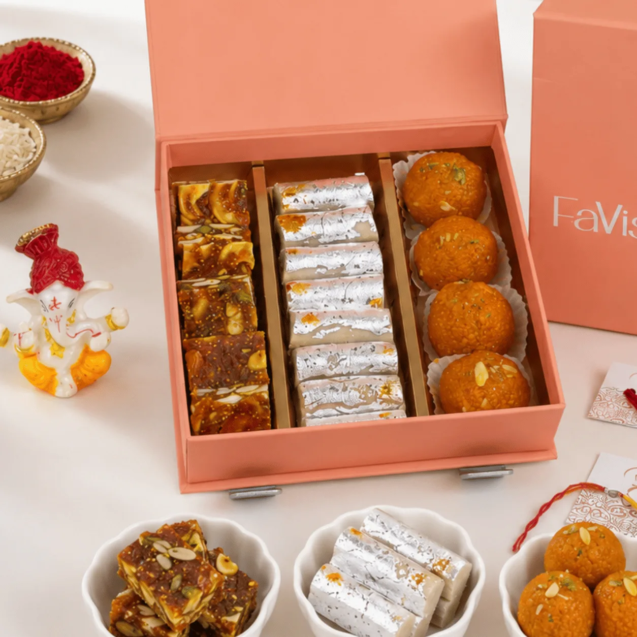 Premium Rakhi Sweets & Ganesha Gift Box for Raksha Bandhan with assorted sweets, Ganesha idol, Rakhi, and premium gift box presentation