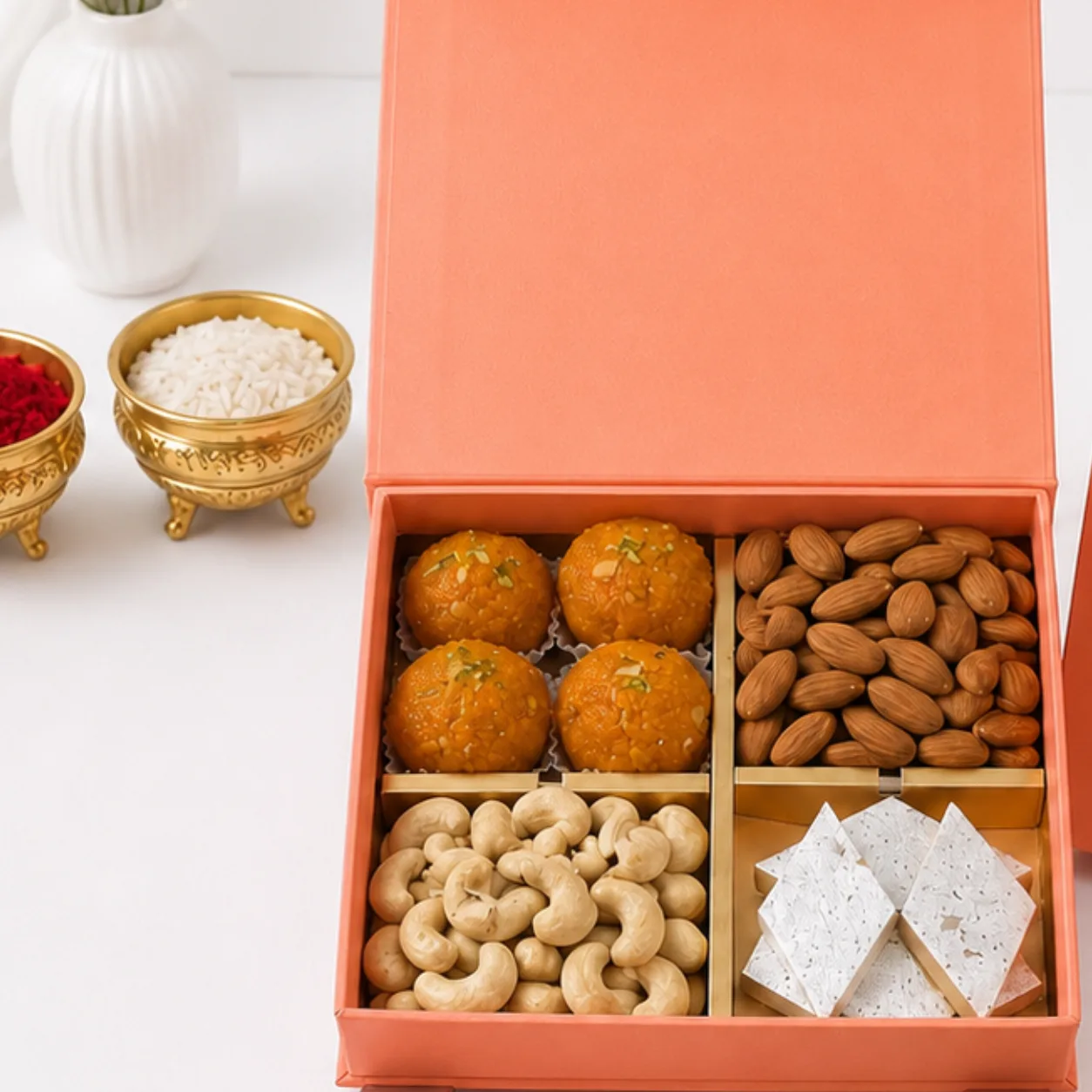 Luxury Festive Dry Fruits Hamper with 2 Rakhis including almonds, roasted cashews, pistachios, complimentary roli and chawal in a premium gift box.
