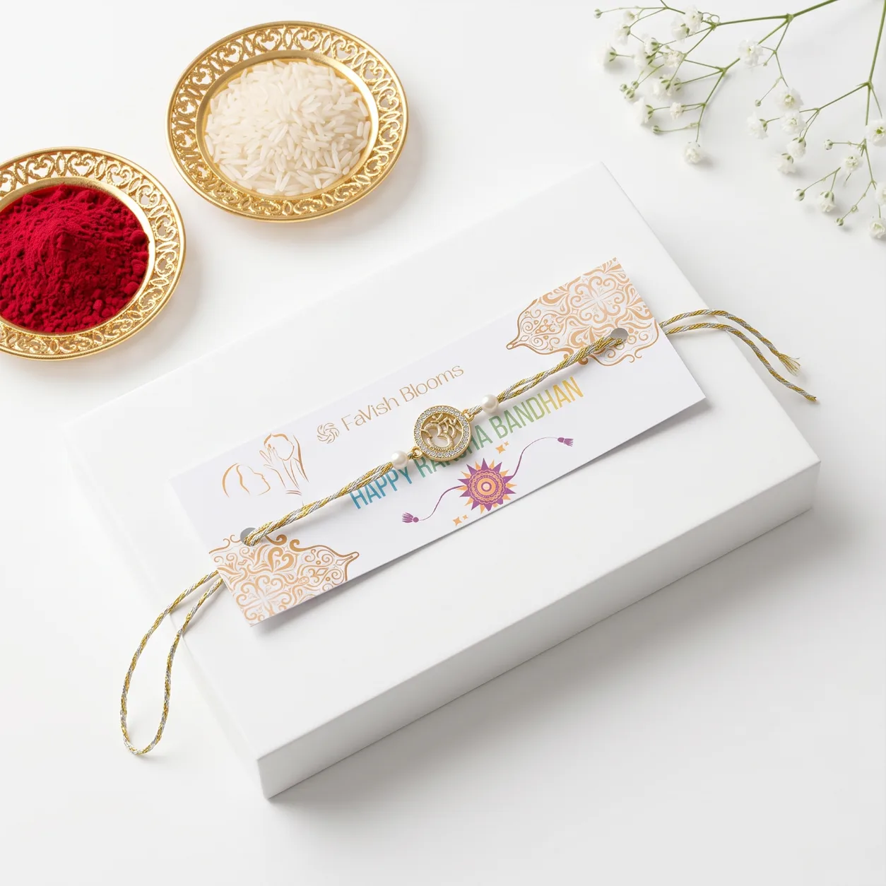Om Design Rakhi with gold-toned centrepiece, pearl accents, and traditional festive detailing.