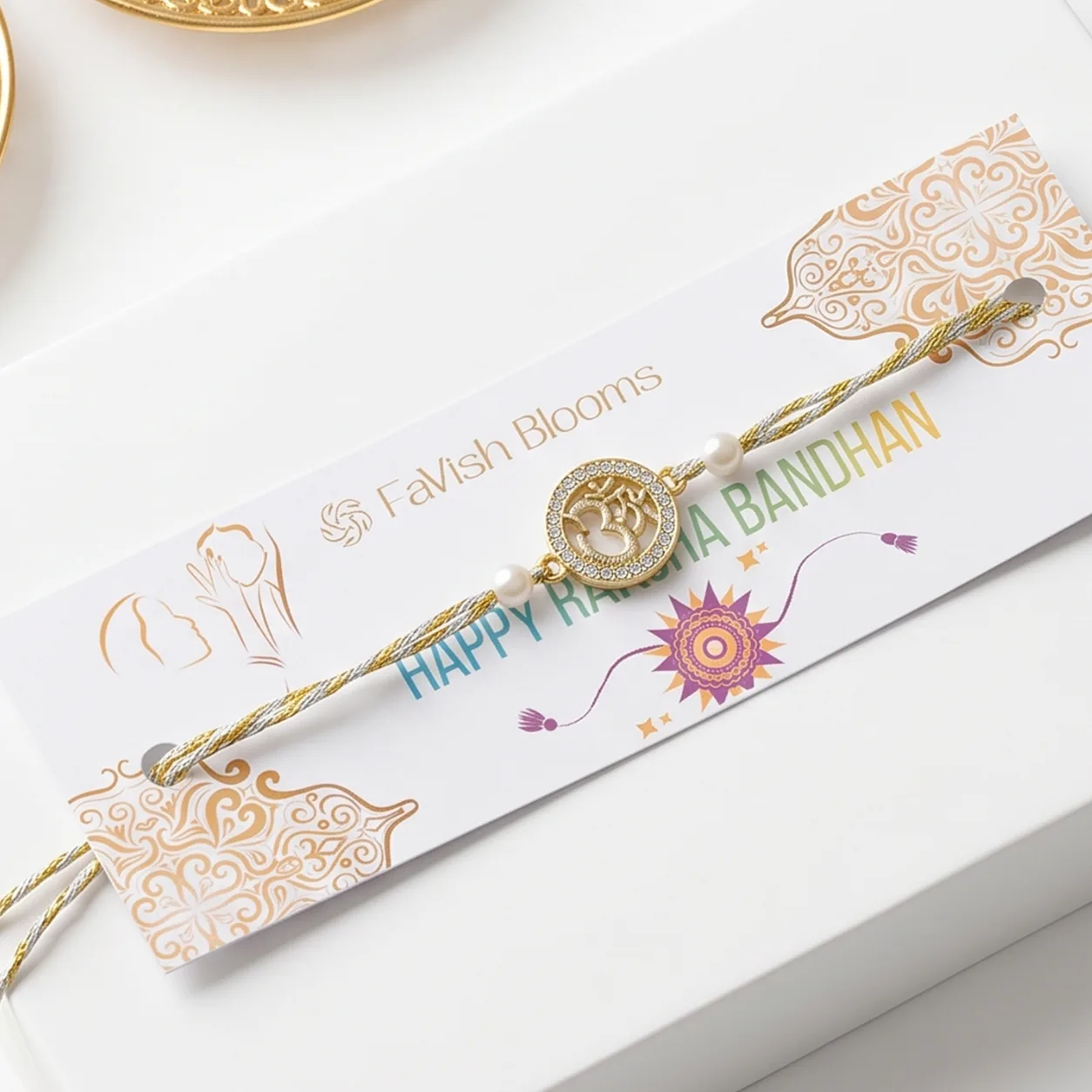 Elegant Om Design Rakhi displayed with complimentary roli and chawal for Raksha Bandhan gifting.